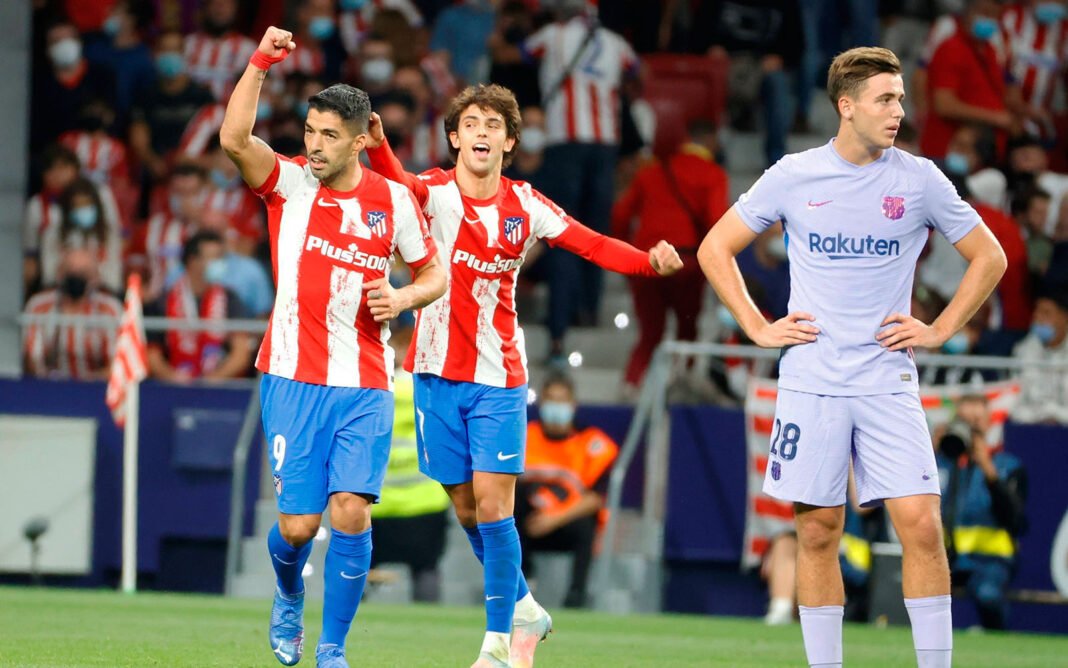 Atletico s Uruguayan striker Luis Suarez (L) celebrates after scoring the 2-0 during the Spanish LaLiga soccer match bet